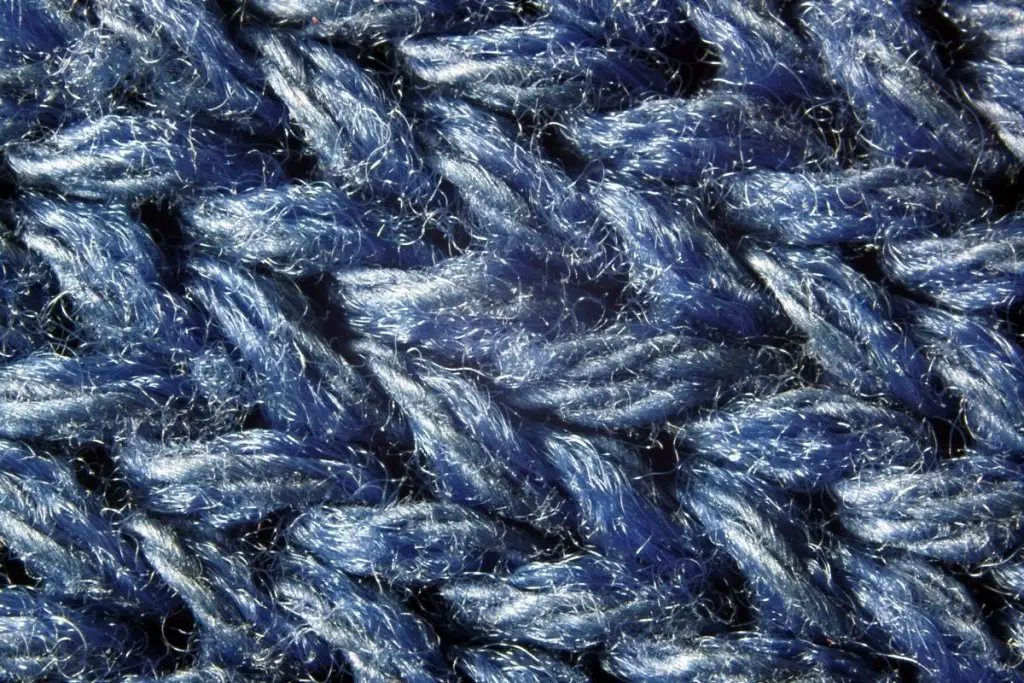 Close-up of wool dyed blue with scratchy fibers