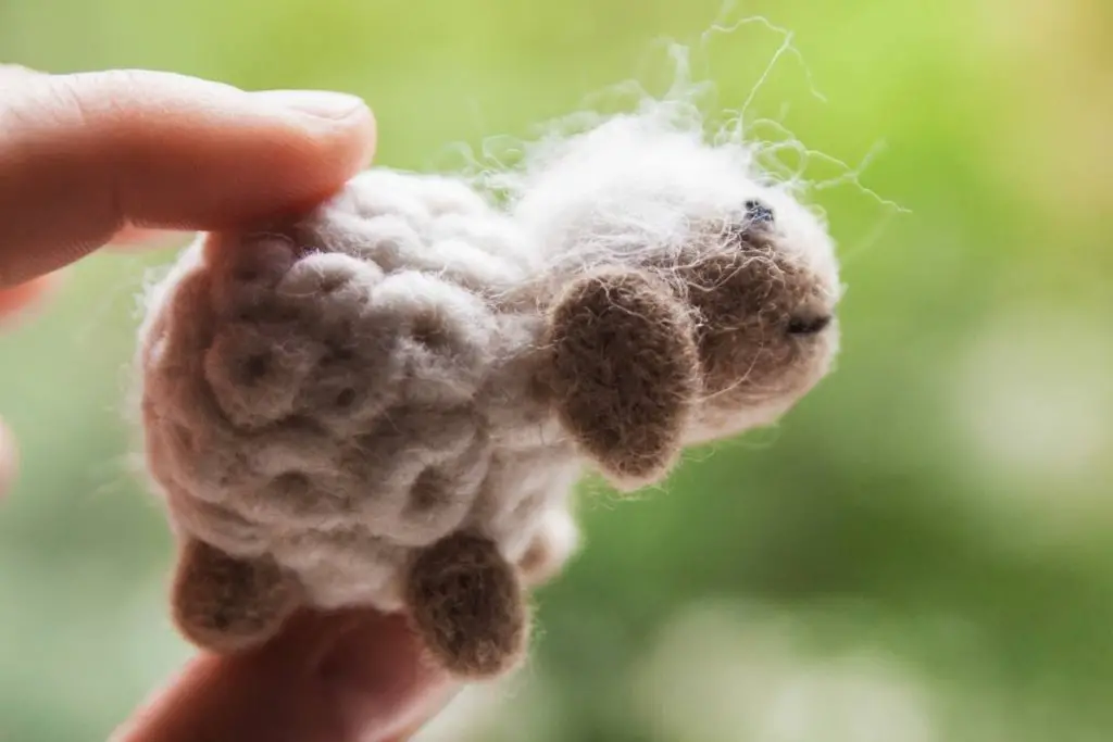 A small sheep toy made out of wool