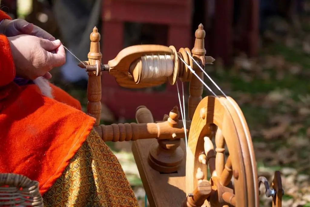 A woman using a spinning wheel